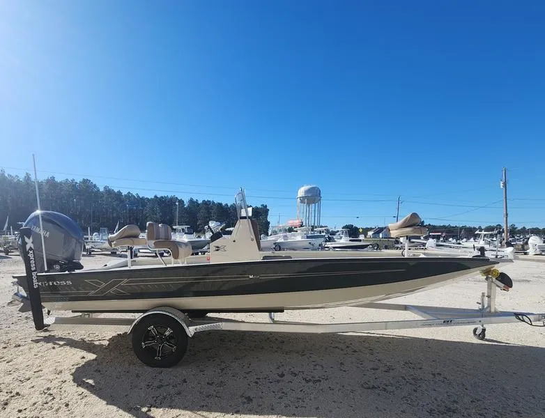 Slide: The Image of 2025 Xpress H22B boat on trailer under clear blue sky. - 2