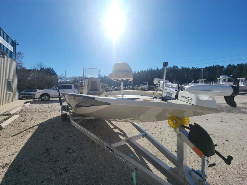 Slide: The Image of 2025 Xpress H22B boat on trailer under bright sun, parked outdoors. - 3