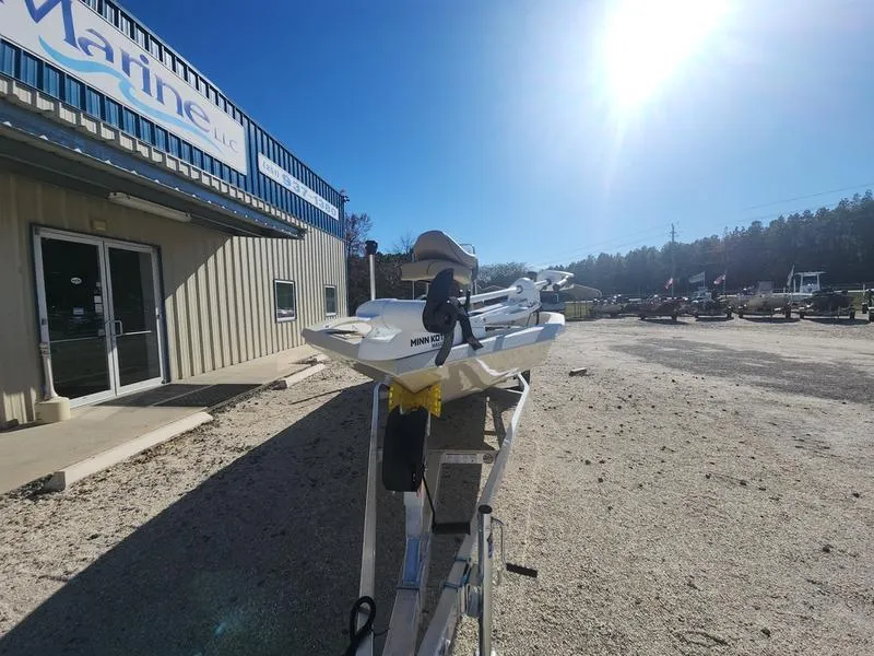 Slide: The Image of 2025 Xpress H22B boat on trailer outside marine dealership under bright sun. - 4