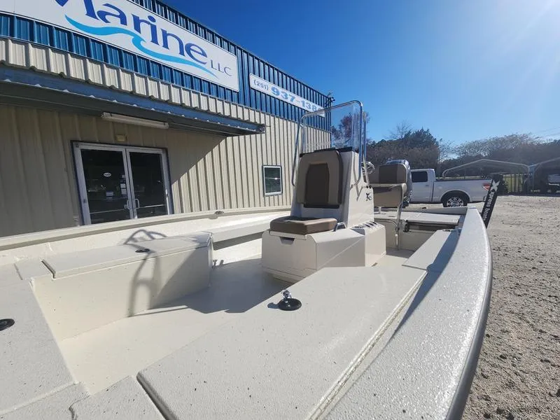 Slide: The Image of 2025 Xpress H22B boat displayed outside a marine dealership under clear blue skies. - 6