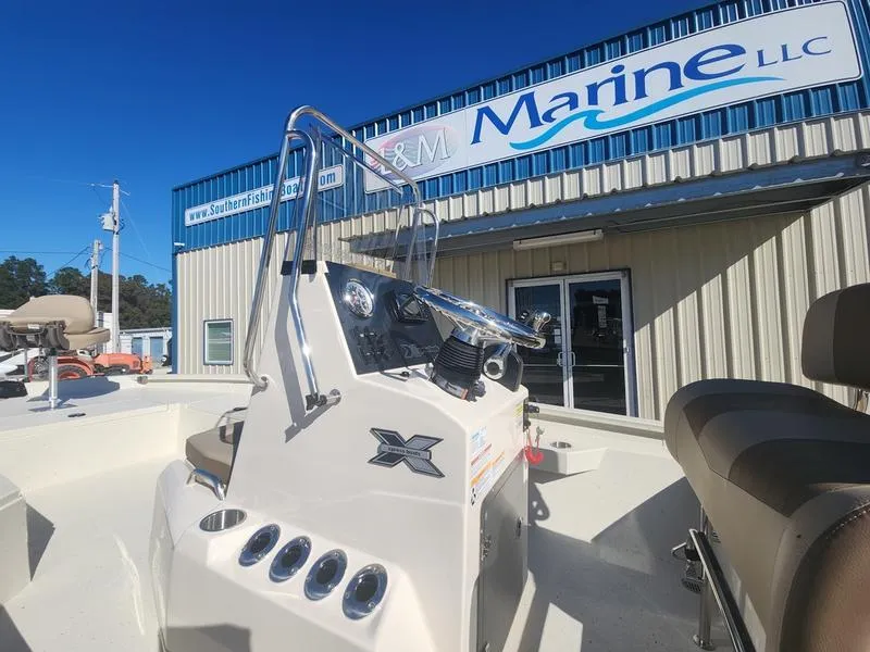 Slide: The Image of 2025 Xpress H22B boat at dealership, featuring console and seating. - 7