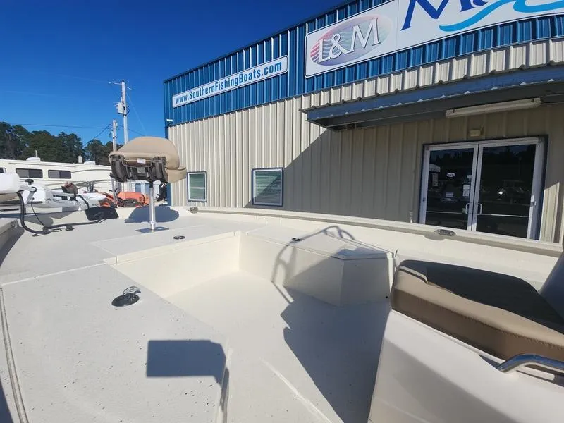 Slide: The Image of 2025 Xpress H22B boat displayed outside a marine dealership under clear blue skies. - 9