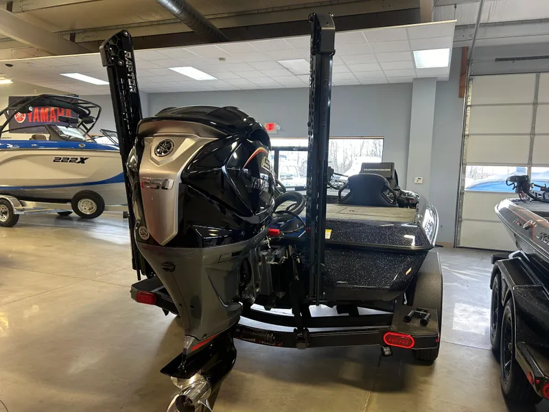 Slide: The Image of 2025 Skeeter ZXR20 boat in showroom, featuring powerful outboard motor and sleek design. - 3