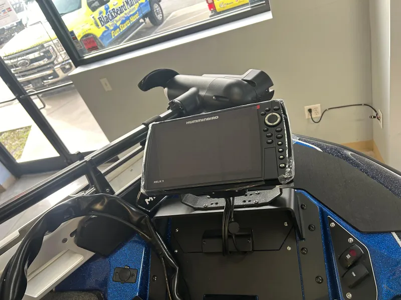 Slide: The Image of 2025 Skeeter ZXR20 boat dashboard with Humminbird fish finder and steering wheel. - 4