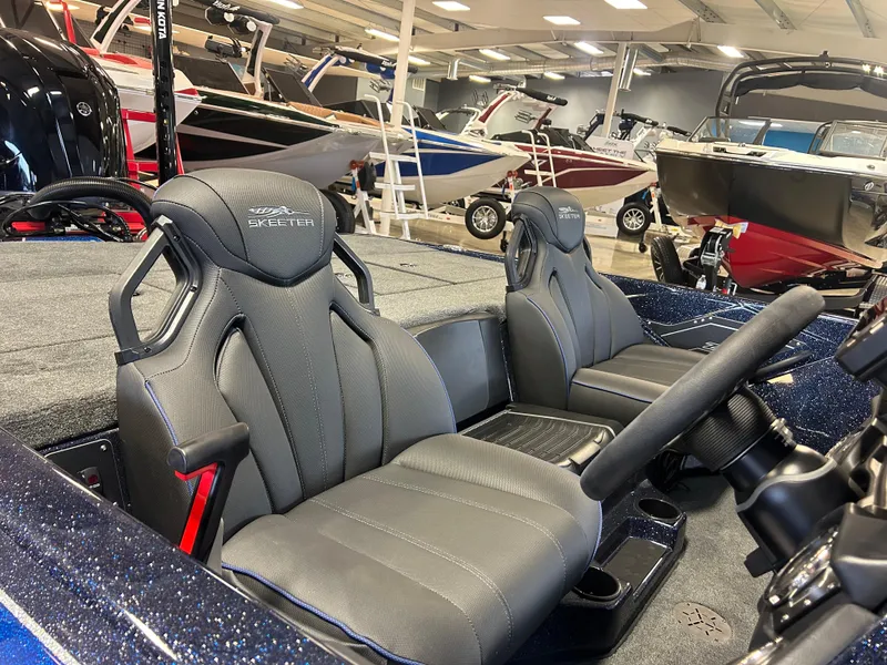 Slide: The Image of 2025 Skeeter ZXR20 boat interior with sleek black seats in showroom. - 5