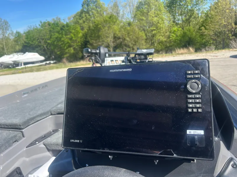 Slide: The Image of Humminbird Xplore 12 fishfinder on 2025 Skeeter ZXR20 boat, outdoors with trees in background. - 4