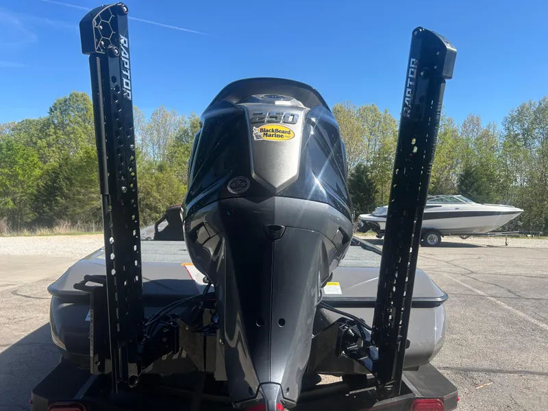 Slide: The Image of 2025 Skeeter ZXR20 boat with powerful outboard motor and Raptor anchors, parked outdoors. - 5