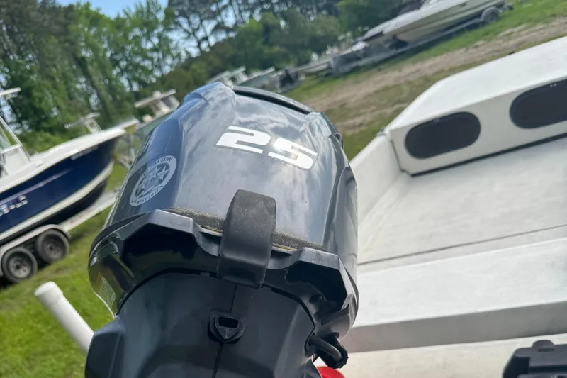 Slide: The Image of 2015 Carolina Skiff J16CC with 25HP outboard motor, parked outdoors. - 3