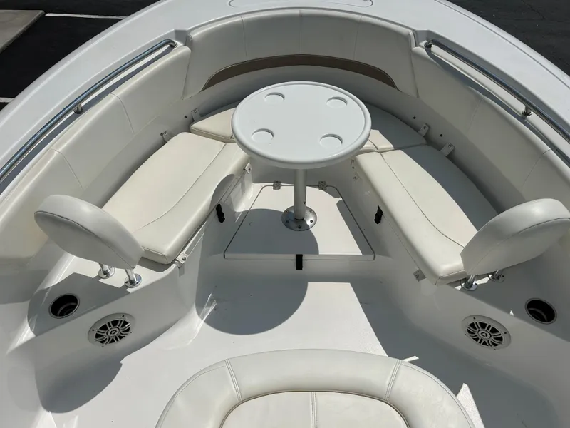 Slide: The Image of 2013 Sportsman 229 Heritage boat interior with white seating and round table. - 15