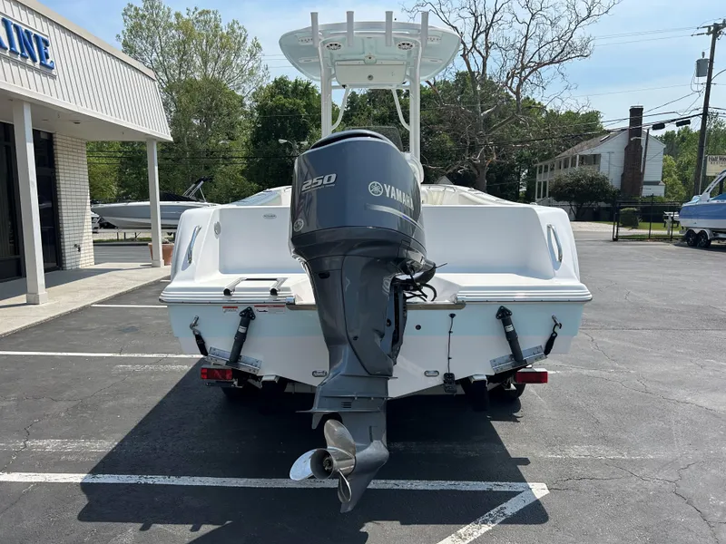 Slide: The Image of 2013 Sportsman 229 Heritage boat with Yamaha 250 engine, parked outdoors. - 5