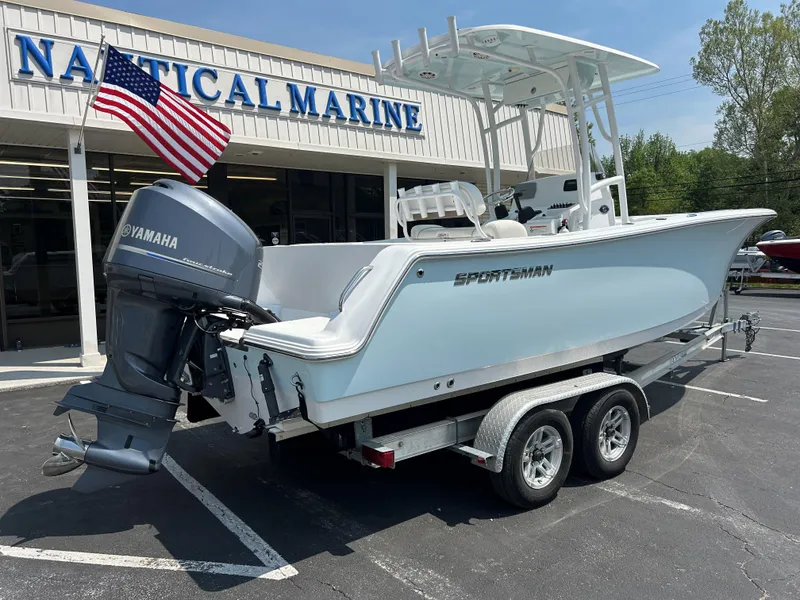 Slide: The Image of 2013 Sportsman 229 Heritage boat on trailer outside Nautical Marine store. - 6