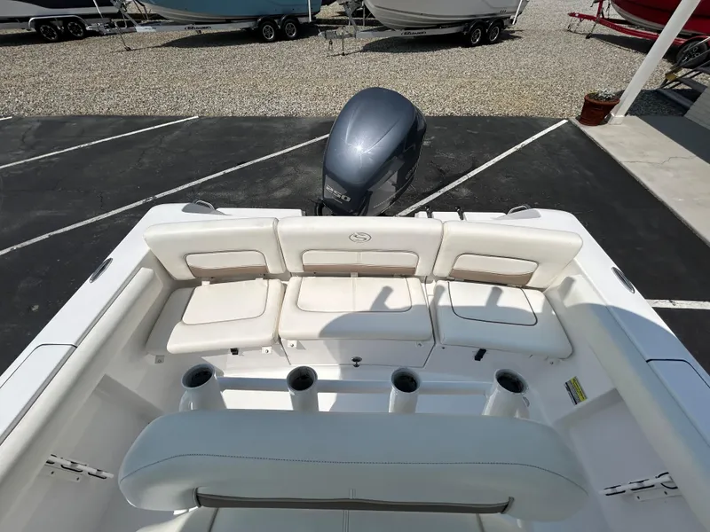 Slide: The Image of 2013 Sportsman 229 Heritage boat interior with seating and motor view. - 7