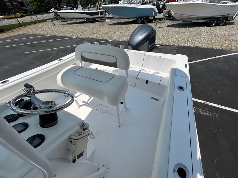 Slide: The Image of 2013 Sportsman 229 Heritage boat interior with steering wheel and seating. - 9