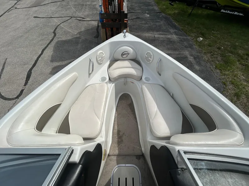 Slide: The Image of 2005 Crownline 180 BR boat interior with white seating and open bow design. - 10