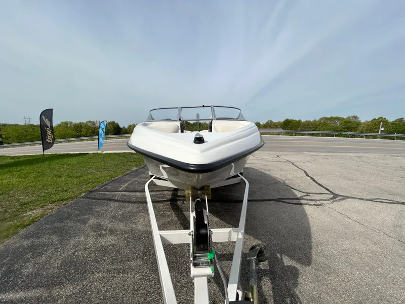 Slide: The Image of 2005 Crownline 180 BR boat on trailer, parked outdoors on a sunny day. - 3