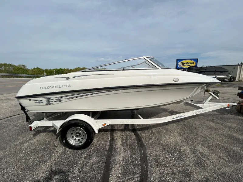 Slide: The Image of 2005 Crownline 180 BR boat on trailer, parked outdoors. - 4