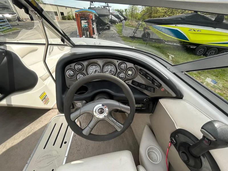 Slide: The Image of 2005 Crownline 180 BR boat dashboard with steering wheel and gauges. - 8