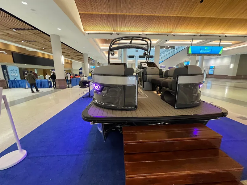 Slide: The Image of 2025 Avalon Excalibur LTD Quad Lounge Windshield boat displayed indoors on blue carpet. - 14