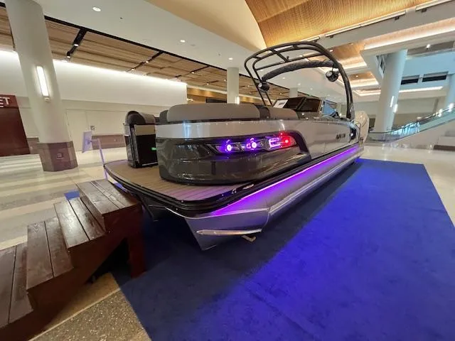 Slide: The Image of 2025 Avalon Excalibur LTD Quad Lounge Windshield boat displayed indoors on blue carpet. - 15