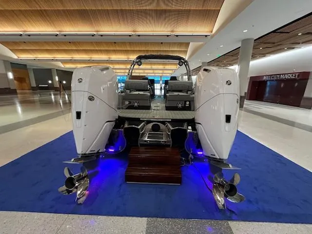 Slide: The Image of 2025 Avalon Excalibur LTD Quad Lounge Windshield boat displayed indoors on blue carpet. - 18