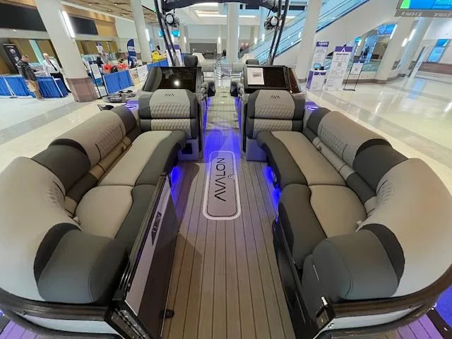 Slide: The Image of Luxurious 2025 Avalon Excalibur LTD Quad Lounge boat with modern seating and ambient lighting. - 20