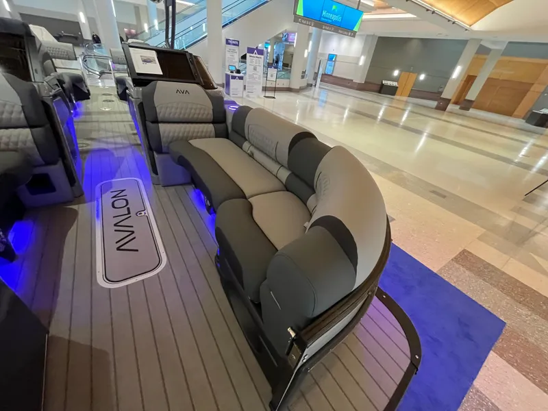 Slide: The Image of 2025 Avalon Excalibur LTD Quad Lounge Windshield boat interior with plush seating and ambient lighting. - 21