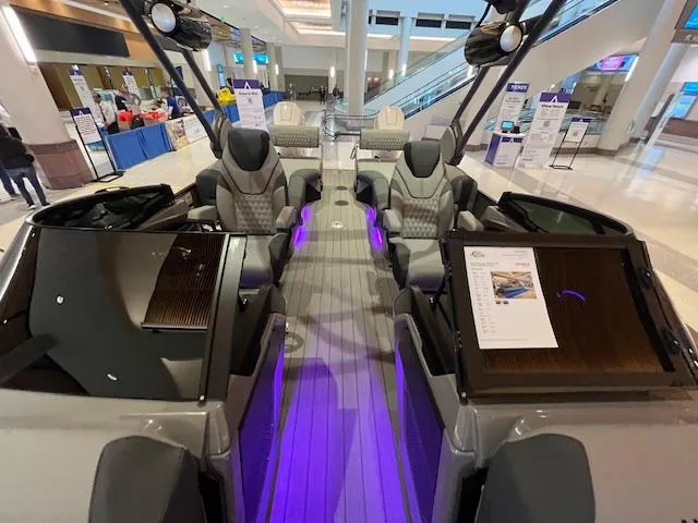 Slide: The Image of 2025 Avalon Excalibur LTD Quad Lounge Windshield boat interior with modern seating and ambient lighting. - 23