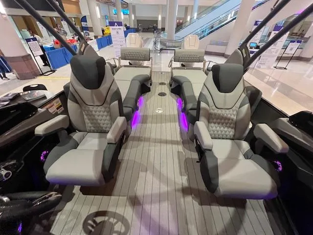 Slide: The Image of Luxurious 2025 Avalon Excalibur LTD Quad Lounge with plush seating and ambient lighting. - 24