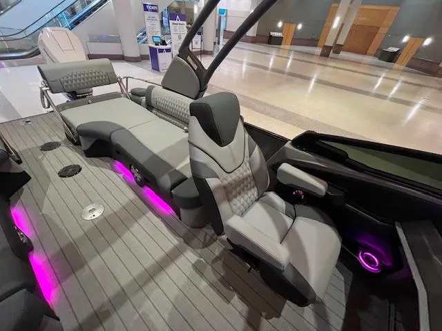 Slide: The Image of 2025 Avalon Excalibur LTD Quad Lounge Windshield boat interior with modern seating and ambient lighting. - 25