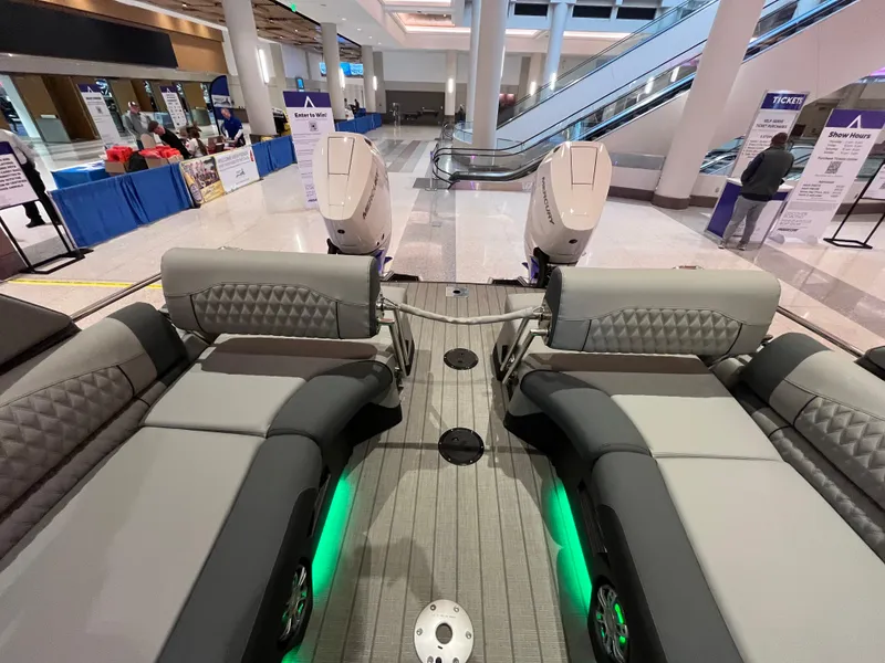 Slide: The Image of 2025 Avalon Excalibur LTD Quad Lounge Windshield boat interior at an indoor exhibition. - 30