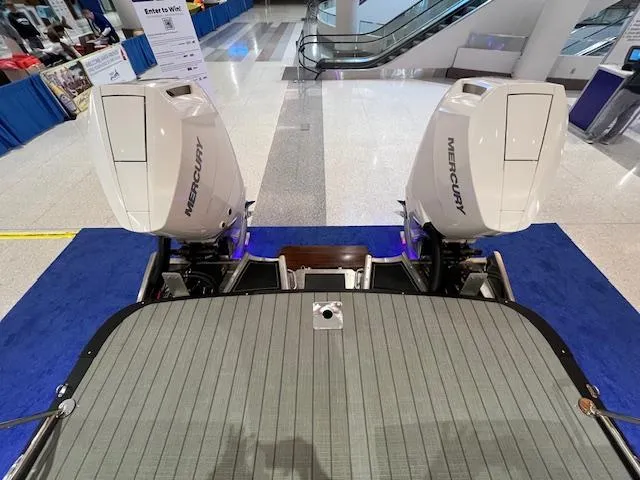Slide: The Image of 2025 Avalon Excalibur LTD boat with dual Mercury outboard engines on display. - 31