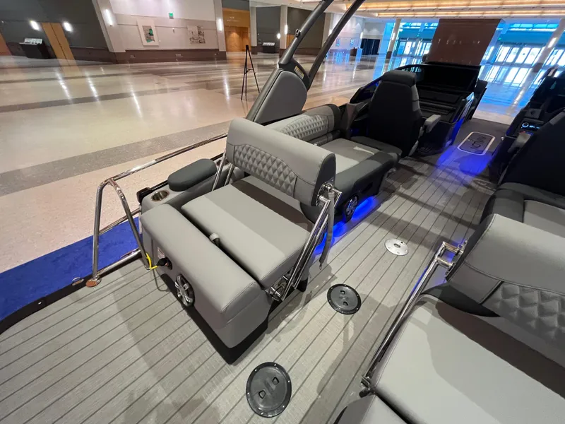 Slide: The Image of 2025 Avalon Excalibur LTD Quad Lounge Windshield boat interior with gray seating and modern design. - 34