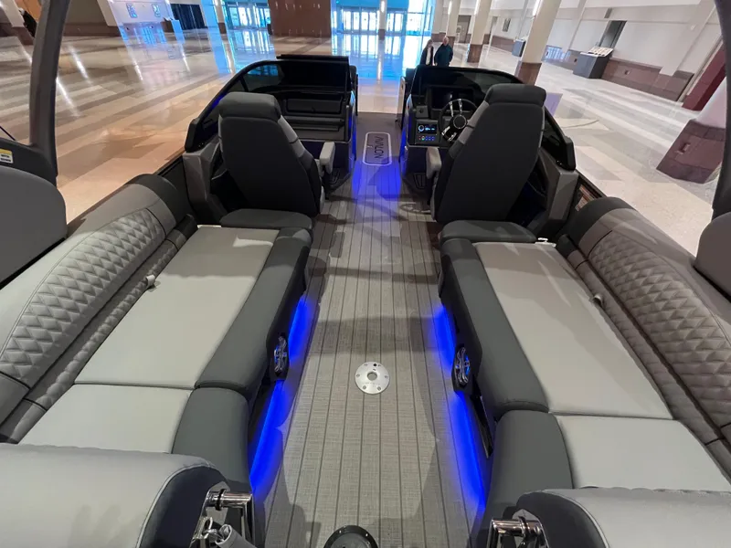 Slide: The Image of Luxurious 2025 Avalon Excalibur LTD Quad Lounge boat interior with blue LED lighting. - 36