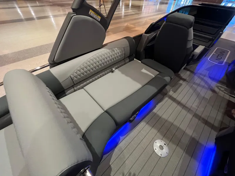 Slide: The Image of 2025 Avalon Excalibur LTD Quad Lounge interior with gray seating and ambient blue lighting. - 37