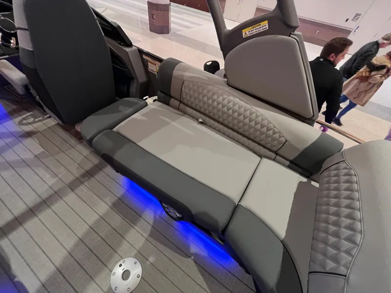 Slide: The Image of 2025 Avalon Excalibur LTD Quad Lounge with windshield, featuring luxurious seating and ambient blue lighting. - 38