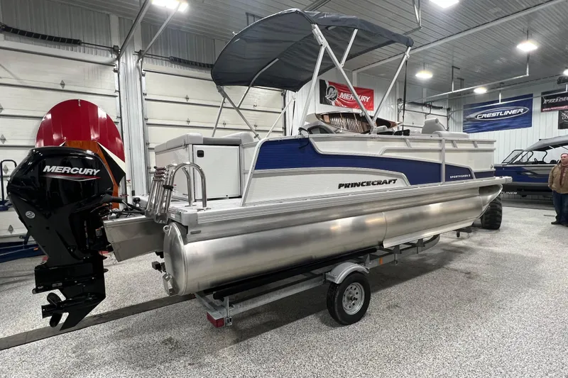 Slide: The Image of 2025 Princecraft Sportfisher 21-2S pontoon boat with Mercury engine in showroom. - 16