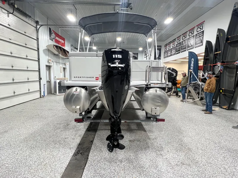 Slide: The Image of 2025 Princecraft Sportfisher 21-2S pontoon boat in showroom, rear view with motor. - 4
