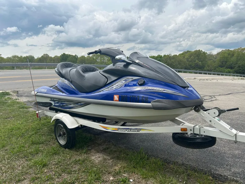 Slide: The Image of 2005 Yamaha WaveRunner FX Cruiser on trailer, parked outdoors under cloudy sky. - 1
