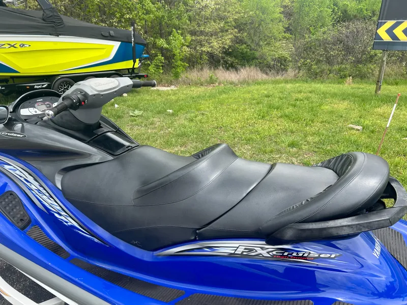 Slide: The Image of 2005 Yamaha WaveRunner FX Cruiser, blue, parked on grass with trees in background. - 6