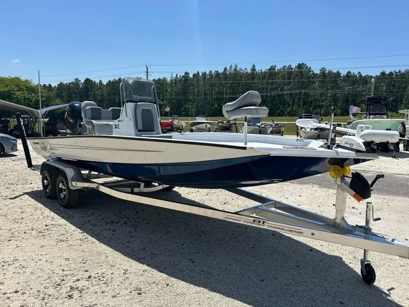 Slide: The Image of 2025 Xpress H22B boat on trailer, parked outdoors under clear sky. - 1