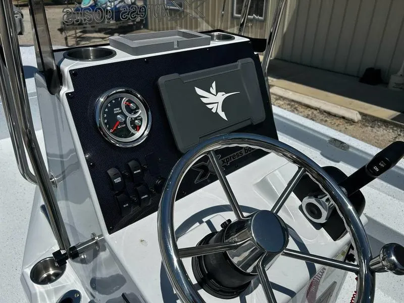 Slide: The Image of Steering console of 2025 Xpress H22B boat with gauges and controls. - 12