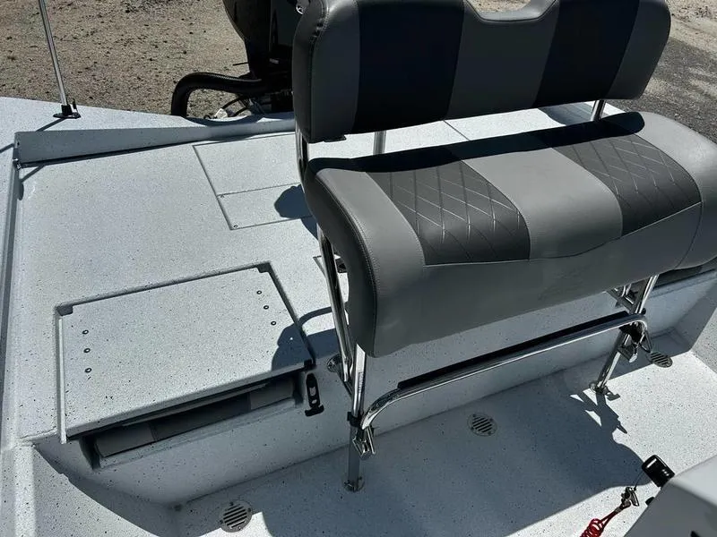 Slide: The Image of 2025 Xpress H22B boat interior with gray seating and storage compartments. - 14