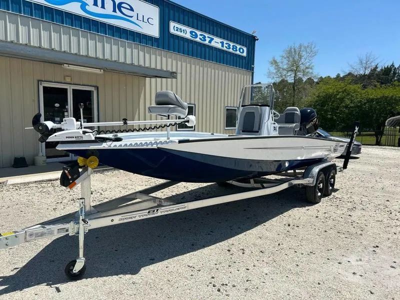 Slide: The Image of 2025 Xpress H22B boat on trailer outside a marine dealership. - 2