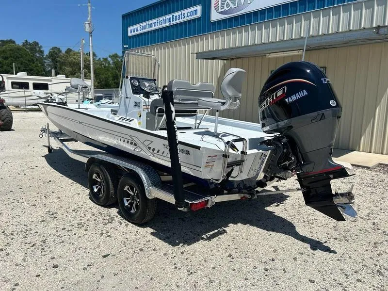 Slide: The Image of 2025 Xpress H22B boat with Yamaha engine on trailer, parked outside a fishing boat dealership. - 3