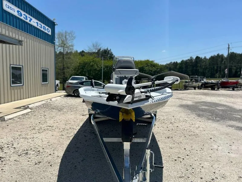 Slide: The Image of 2025 Xpress H22B boat on trailer outside dealership, sunny day. - 6