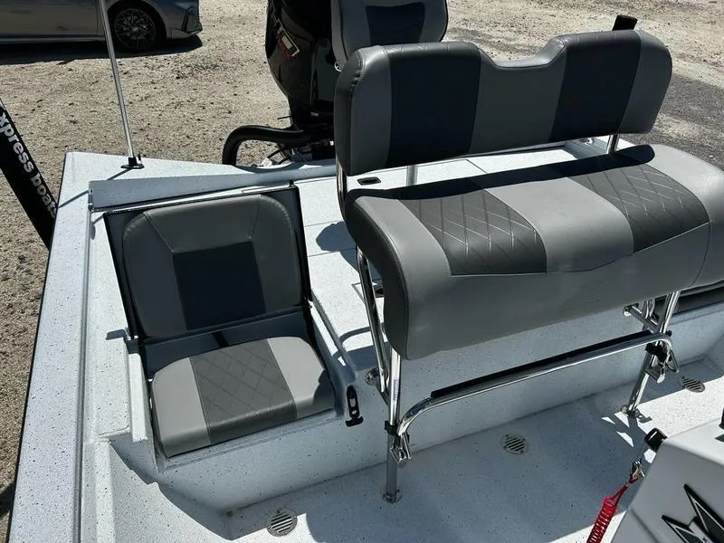 Slide: The Image of 2025 Xpress H22B boat interior with dual gray seats and textured upholstery. - 9