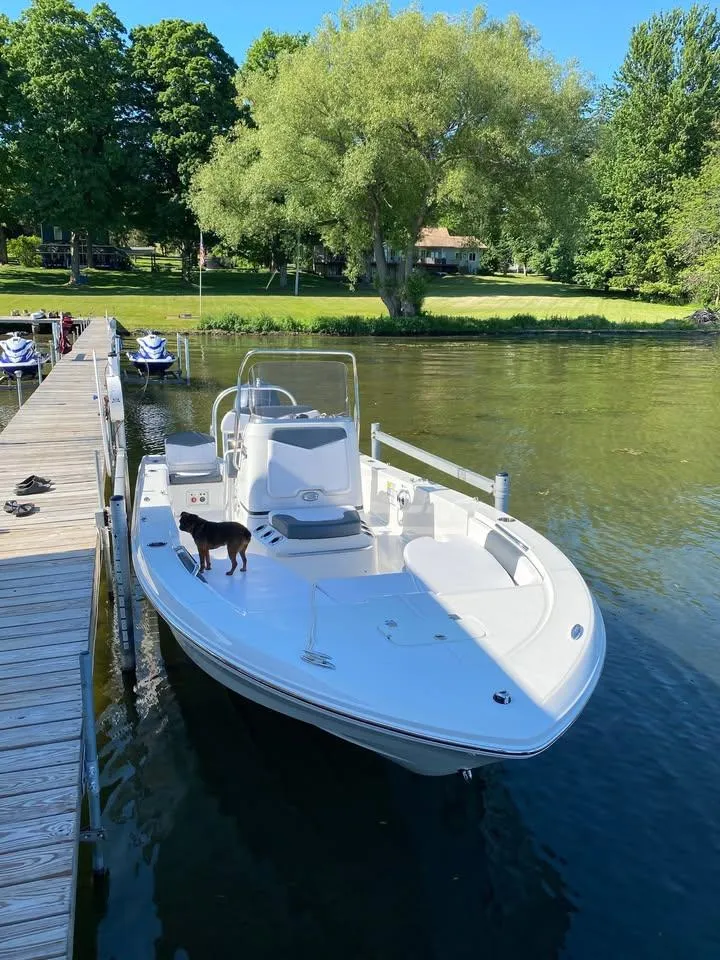 Slide: The Image of 2020 Yamaha Boats Robalo docked on a serene lake with lush greenery. - 5