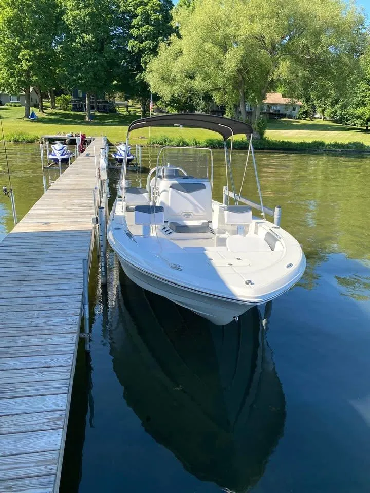 Slide: The Image of 2020 Yamaha Boats Robalo docked on a serene lake with lush greenery. - 6