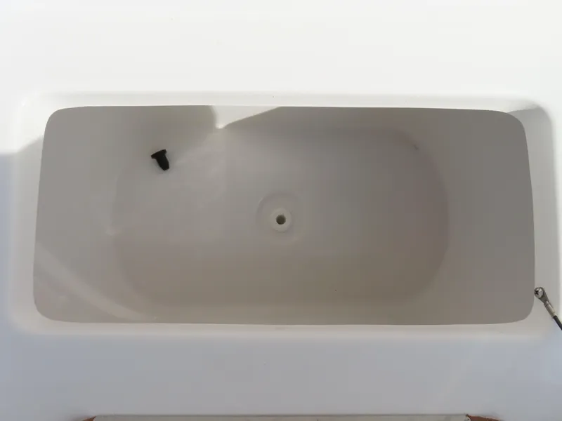 Slide: The Image of 2024 Sea Hunt Ultra 239 SE boat storage compartment, white interior, top view. - 18