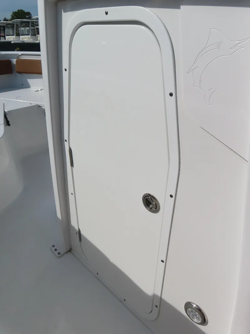 Slide: The Image of 2024 Sea Hunt Ultra 239 SE boat storage compartment door. - 19